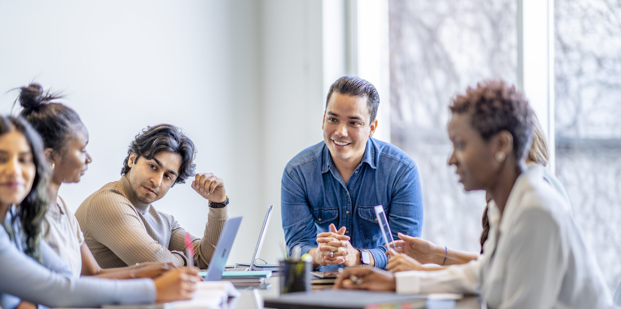 People sitting around desk having a meeting
