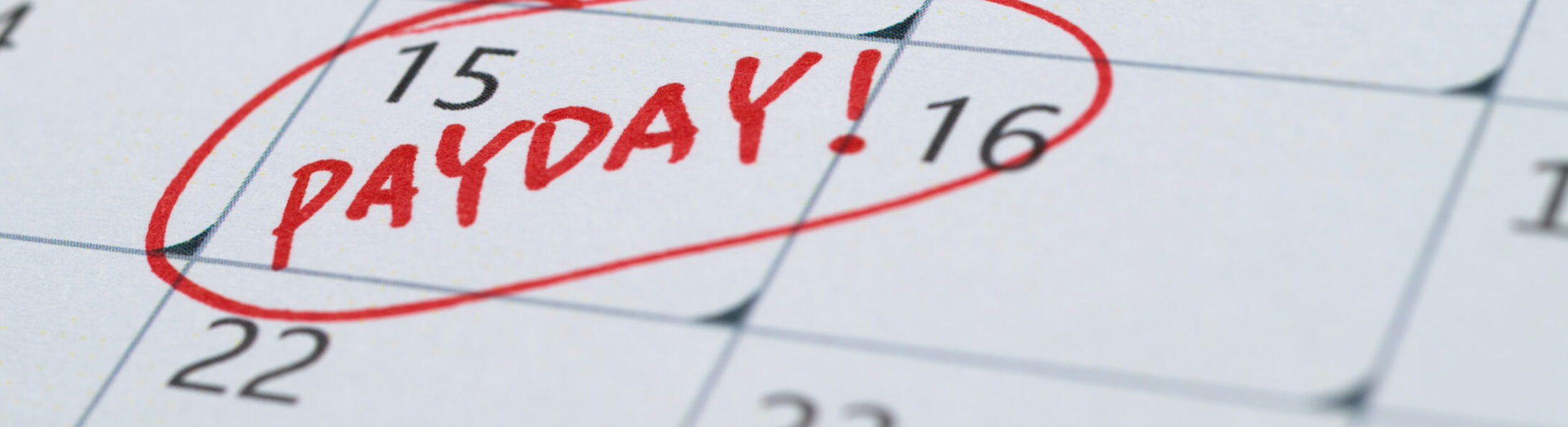 Photo of a calendar with the word Payday circled on it